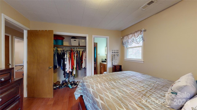 bedroom featuring hardwood / wood-style flooring and a closet