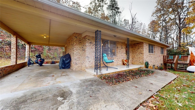 view of patio featuring a carport and a wooden deck