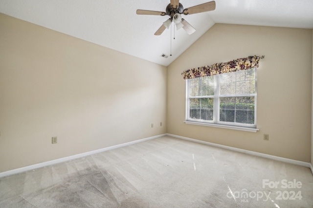 carpeted empty room featuring ceiling fan and vaulted ceiling