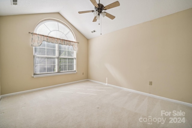 unfurnished room with ceiling fan, light colored carpet, and lofted ceiling