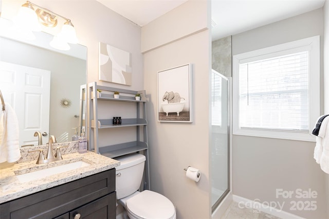 312 Jenna Clare Ln, Asheville, NC 28803 - bathroom with a shower with door, toilet, vanity, baseboards, and tile patterned flooring