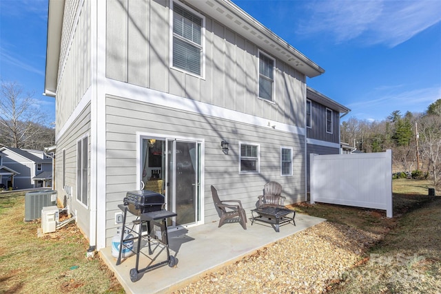 312 Jenna Clare Ln, Asheville, NC 28803 - back of house featuring central AC unit, a patio area, board and batten siding, and an outdoor fire pit