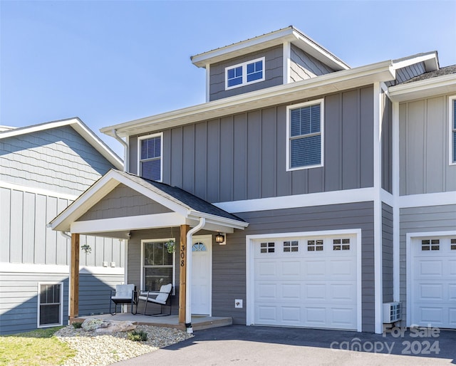 view of front facade featuring a porch and a garage