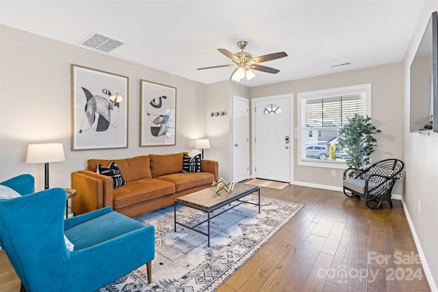 living room featuring hardwood / wood-style flooring and ceiling fan