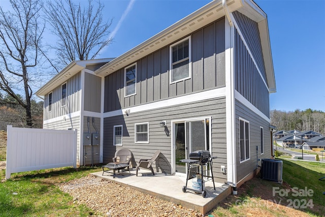 rear view of house featuring a patio and cooling unit