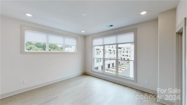 unfurnished room featuring light wood-type flooring