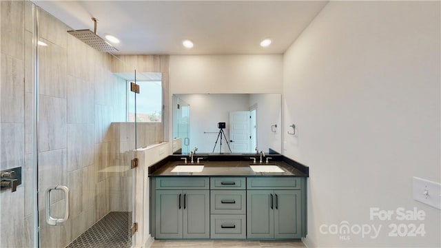 bathroom with vanity, tile patterned flooring, and a shower with door