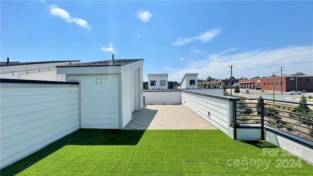 view of yard with a balcony