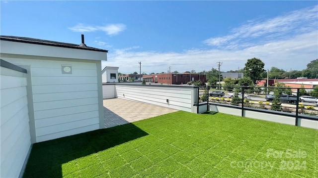 view of yard with a balcony