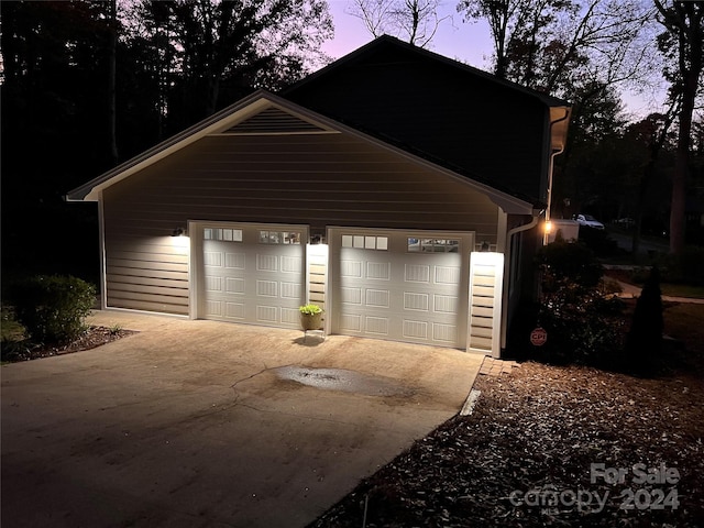 view of garage at dusk