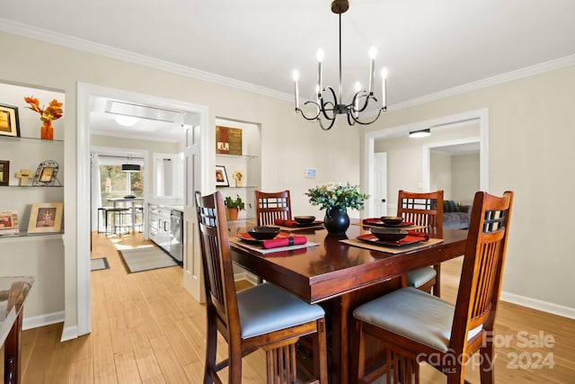 dining room with a notable chandelier, light wood-type flooring, and crown molding