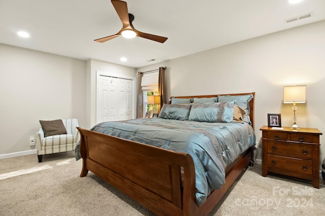 bedroom featuring ceiling fan, a closet, and light carpet