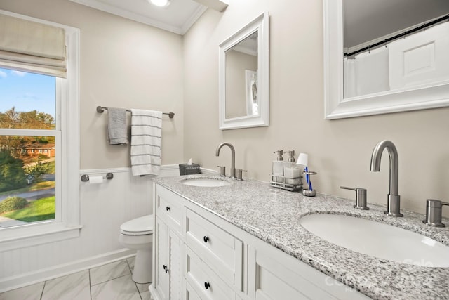 bathroom with vanity, toilet, and crown molding