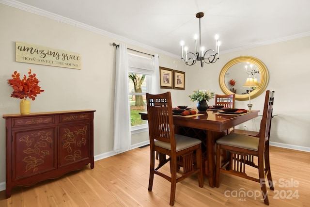 dining room featuring a chandelier, ornamental molding, and light wood-type flooring