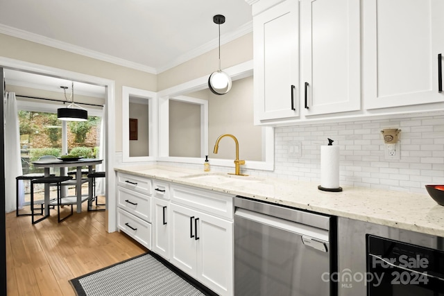 kitchen with dishwasher, white cabinetry, hanging light fixtures, and sink