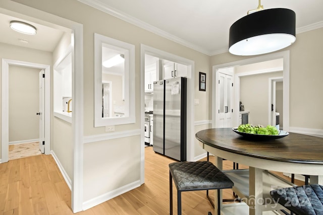 interior space with light hardwood / wood-style floors and crown molding