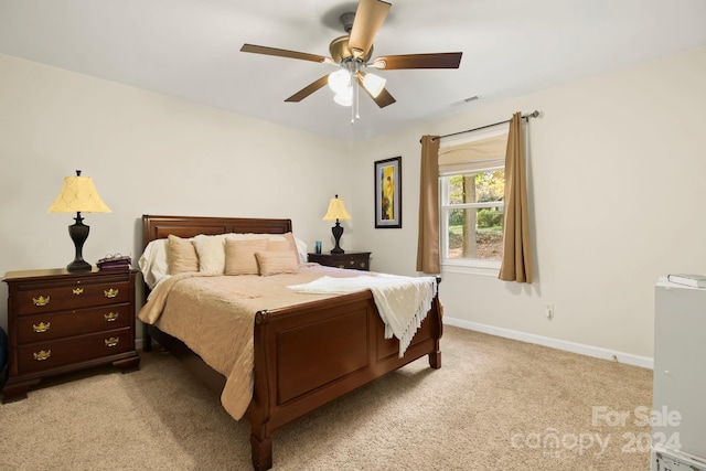 bedroom featuring ceiling fan and light carpet