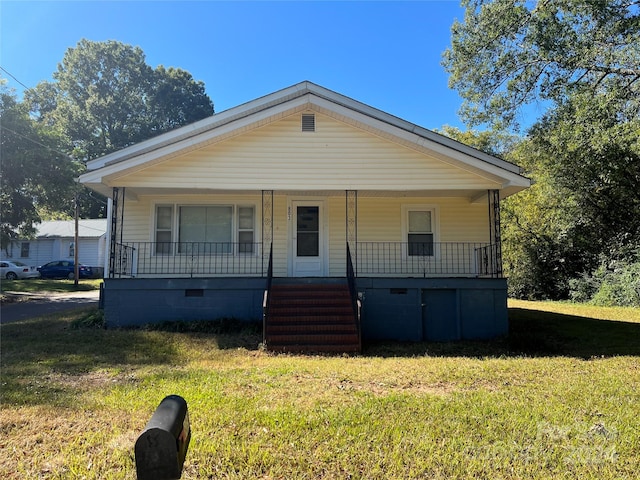 bungalow-style house featuring a front yard and covered porch