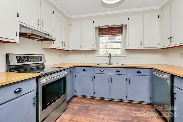 kitchen featuring white cabinetry, sink, appliances with stainless steel finishes, ornamental molding, and dark wood-type flooring