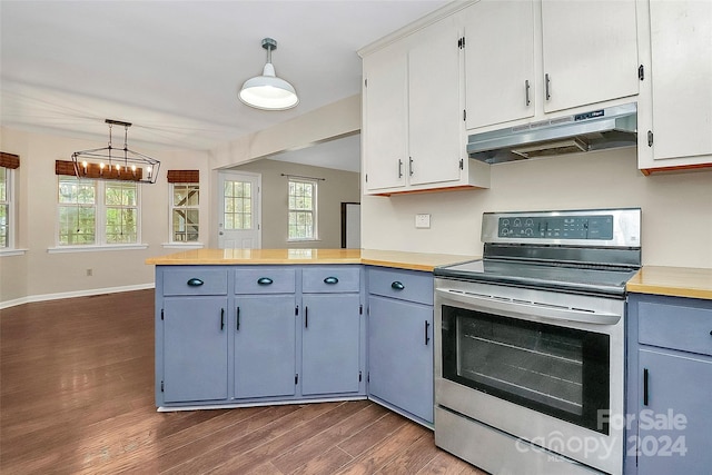 kitchen with dark hardwood / wood-style floors, stainless steel range with electric cooktop, hanging light fixtures, blue cabinetry, and white cabinets