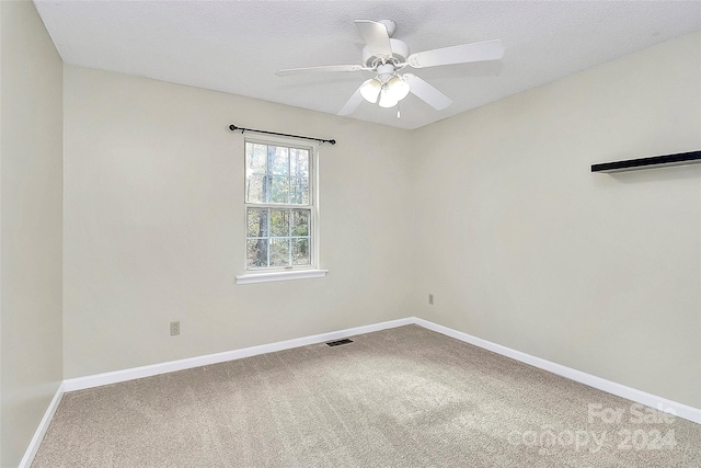 unfurnished room featuring a textured ceiling, carpet floors, and ceiling fan