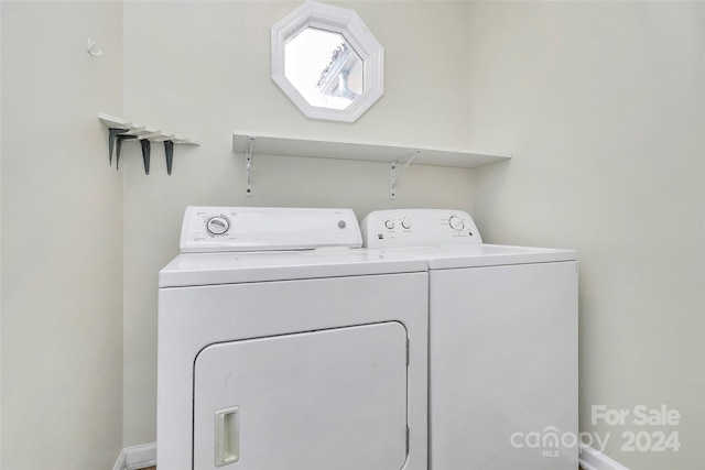 clothes washing area with washer and dryer