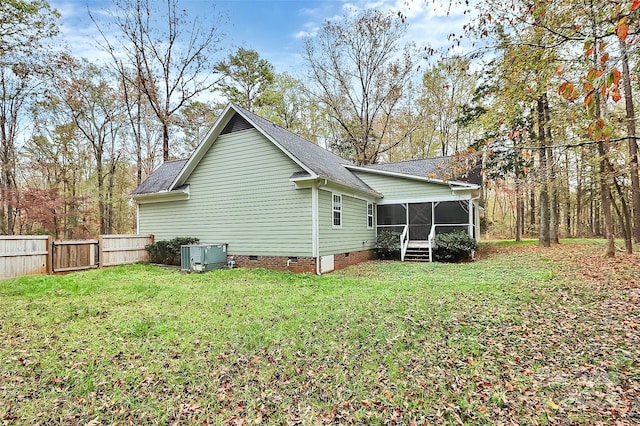 view of property exterior featuring a lawn and a sunroom