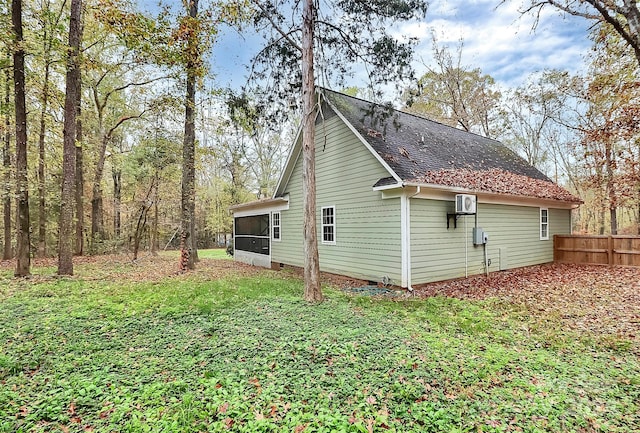 view of side of property featuring a sunroom and a lawn