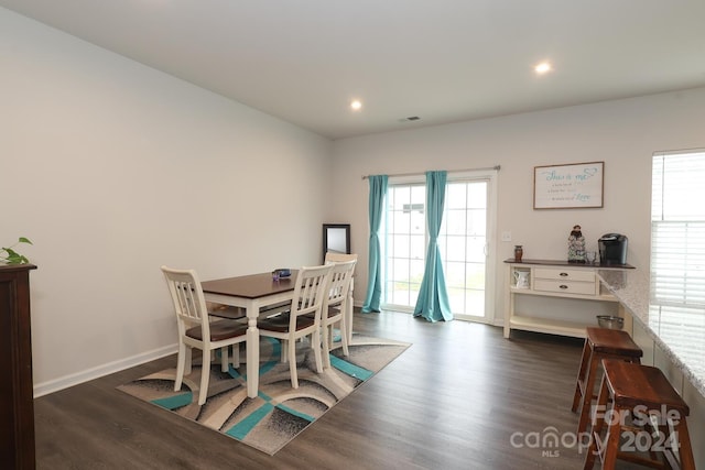 dining space with dark hardwood / wood-style floors