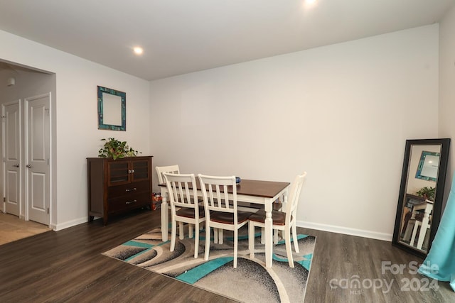 dining space featuring dark wood-type flooring