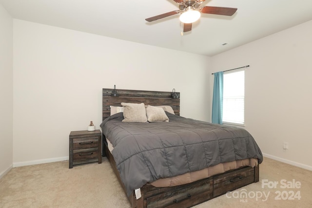 bedroom featuring ceiling fan and light carpet