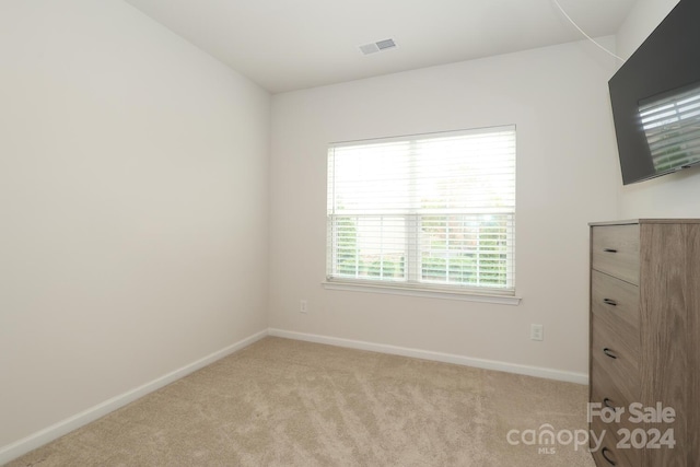 empty room featuring light colored carpet