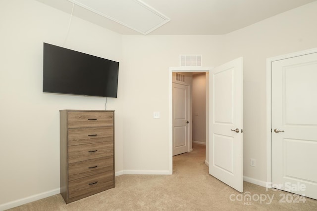 unfurnished bedroom featuring light carpet