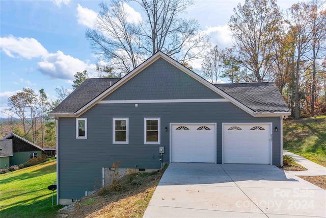 2637 Bowden Ln, Hendersonville, NC 28792 - view of home's exterior with concrete driveway, an attached garage, roof with shingles, and a yard