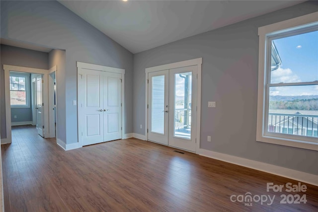 entryway with hardwood / wood-style floors, lofted ceiling, and french doors