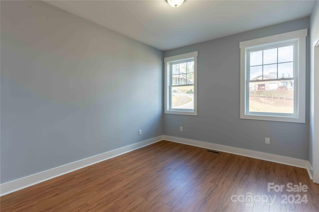 empty room with hardwood / wood-style floors