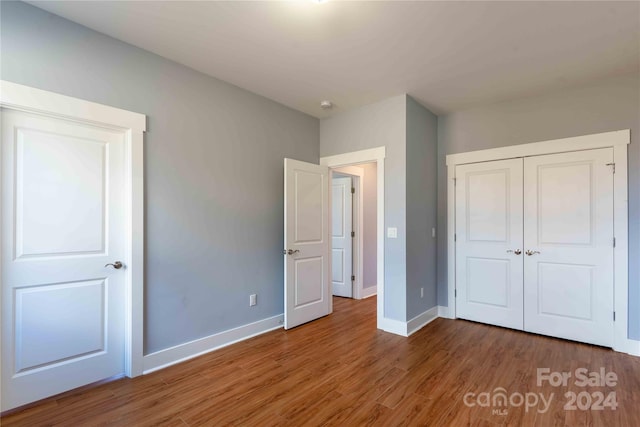 2637 Bowden Ln, Hendersonville, NC 28792 - unfurnished bedroom with wood finished floors, baseboards, and a closet