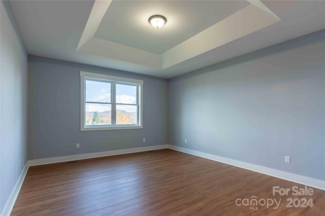 2637 Bowden Ln, Hendersonville, NC 28792 - unfurnished room with a tray ceiling, wood finished floors, and baseboards