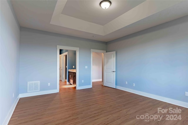 2637 Bowden Ln, Hendersonville, NC 28792 - unfurnished bedroom with wood finished floors, baseboards, and a raised ceiling
