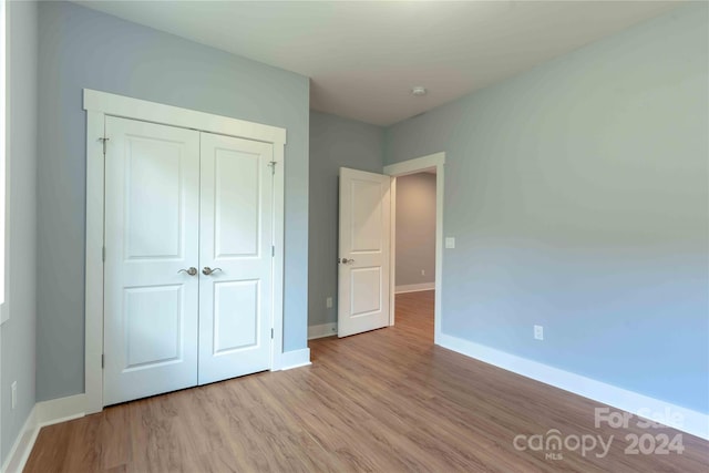 2637 Bowden Ln, Hendersonville, NC 28792 - unfurnished bedroom featuring baseboards, wood finished floors, and a closet