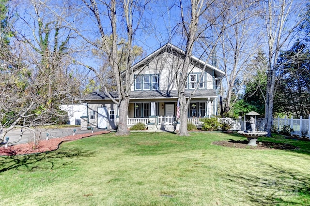 view of front facade with covered porch and a front yard