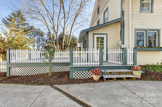 exterior space featuring a wooden deck and a patio