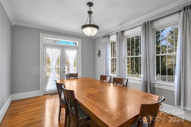 dining area featuring light hardwood / wood-style flooring, french doors, ornamental molding, and plenty of natural light