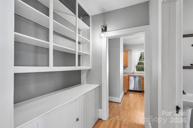 corridor with light hardwood / wood-style floors