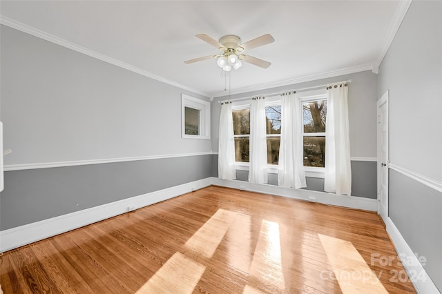 empty room with ornamental molding, hardwood / wood-style flooring, and ceiling fan