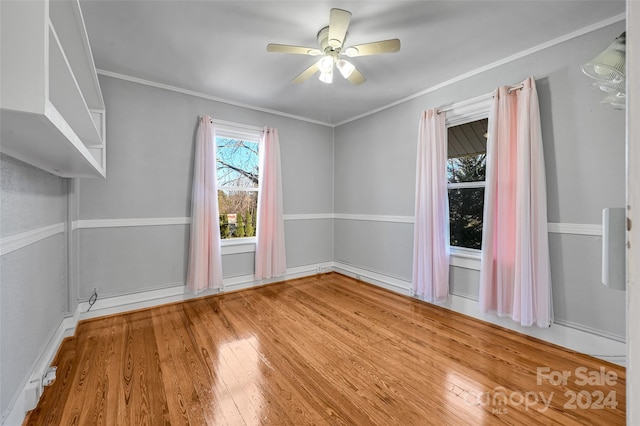 unfurnished room featuring hardwood / wood-style floors, ceiling fan, and crown molding