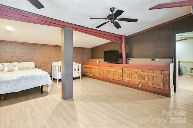 bedroom featuring lofted ceiling, hardwood / wood-style flooring, and ceiling fan