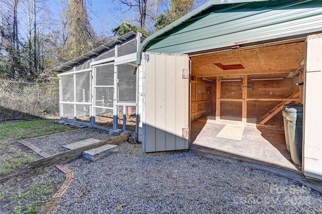 view of outbuilding with a sunroom