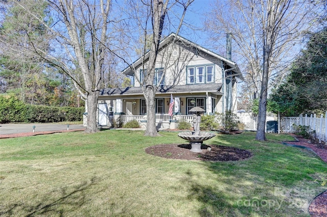 view of front of property featuring a front yard and covered porch