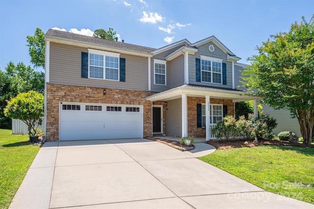 view of front of house with a front lawn, a garage, and a porch